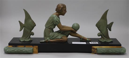 An Art Deco model of a girl with a ball, on black marble base